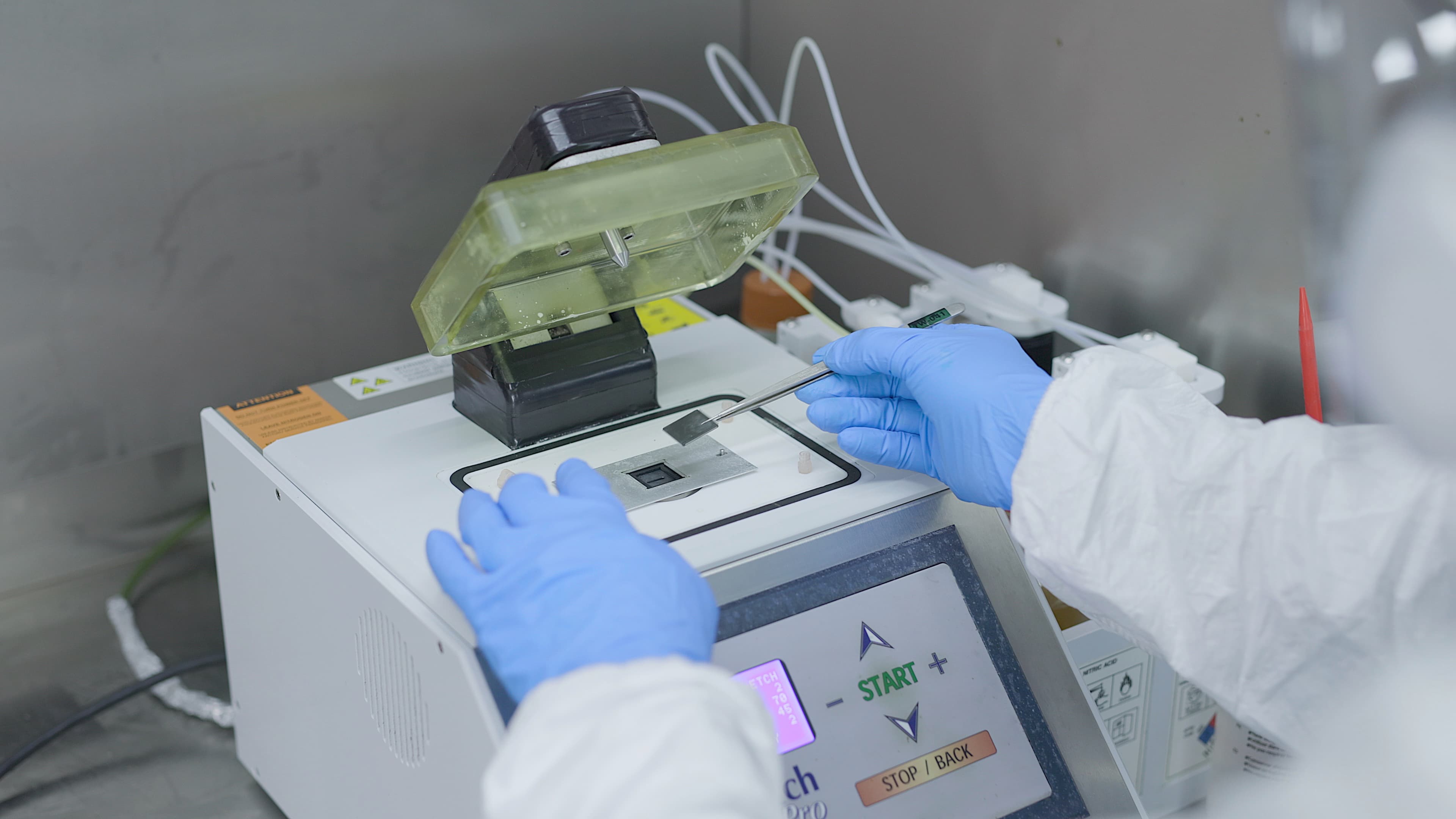 Fusion quality control inspector placing a microchip on a machine